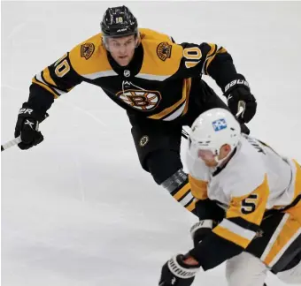  ?? MATT sTONE / HERALD sTAFF ?? LOOKING FOR A SCORE: Bruins winger Anders Bjork chases down Pittsburgh’s Mike Matheson during the first period Thursday night at TD Garden.