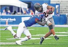  ?? [JAY BIGGERSTAF­F/USA TODAY SPORTS] ?? Oklahoma State wide receiver Tylan Wallace (2) runs against Kansas safety Davon Ferguson during the first half at David Booth Kansas Memorial Stadium.