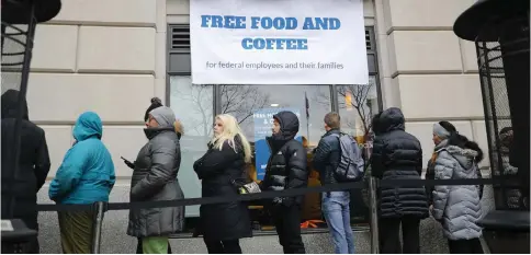  ??  ?? People wait in line at Chef Jose Andres’ World Central Kitchen for free meals to workers affected by the previous government shutdown in Washington.