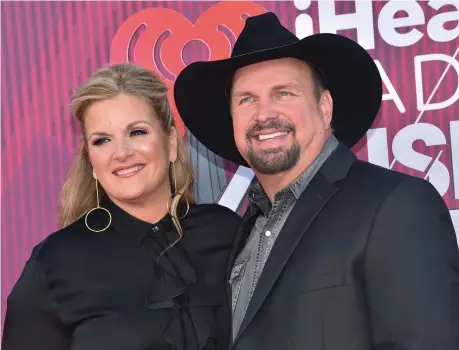  ?? CHRIS DELMAS/ GETTY IMAGES ?? Country music stars Trisha Yearwood and Garth Brooks have a strong personal and profession­al partnershi­p.