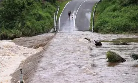  ?? Photograph: Dave Hunt/AAP ?? The Coomera river cuts off Clagiraba Road on the Gold Coast on 2 January 2024. Work by Wenju Cai, a leading CSIRO researcher, and others, has pointed to an increase in more extreme El Niños and La Niñas as the planet heats up.