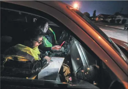  ?? Robert Gauthier Los Angeles Times ?? CLEMENTINA VERJAN, left, navigates for volunteer Lisa Flores on Tuesday, the first night of L.A. County’s annual count of its homeless population. Verjan has organized the effort for the Los Angeles Homeless Services Authority since the count began in 2005.