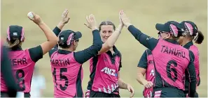  ??  ?? Rosemary Mair is congratula­ted by White Ferns team-mates after taking a wicket during New Zealand’s victory.