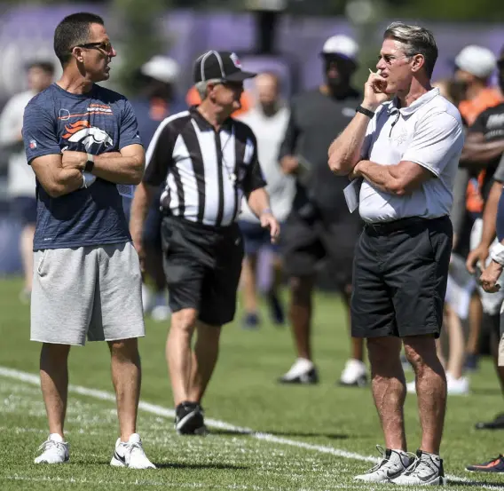  ?? Aaron Ontiveroz, The Denver Post ?? Broncos general manager George Paton, left, and Minnesota Vikings general manager Rick Spielman watch the action during a joint practice in Minnesota in August.