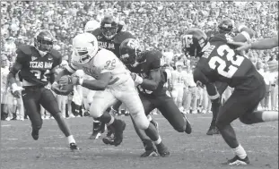  ?? Fort Worth Star-telegram/tns ?? In a 2001 file image, Texas’ Cedric Benson breaks free of the Texas A&M defense for his second touchdown in the Longhorns’ 21-7 victory.