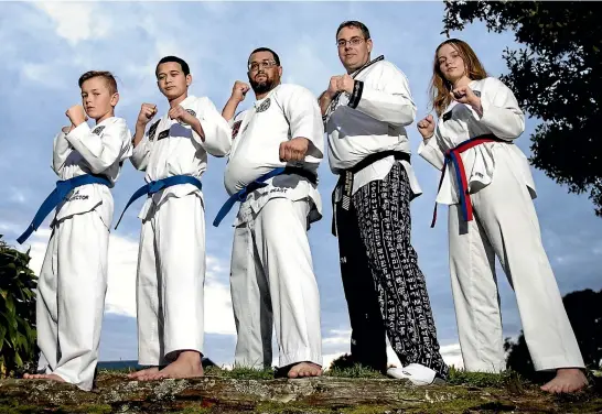 ?? ANDY JACKSON/STUFF ?? A group of Taranaki martial artists have gone from preparing for their first big national contest to getting set for a world championsh­ip next year. Pictured are Royden Whitham, 11, Nihmaren Ioane, 14, Manny Sadler, coach Steve Drummond and Maddison Gibbs, 16.