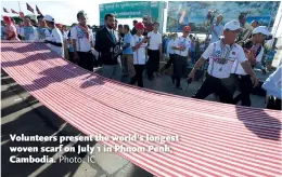  ?? Photo: IC ?? Volunteers present the world’s longest woven scarf on July 1 in Phnom Penh, Cambodia.