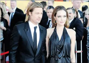  ?? Frazer Harrison, Getty Images ?? Angelina Jolie, wearing a black Jenny Peckham gown, arrives at the Screen
Actors Guild Awards with Brad Pitt on Sunday in Los Angeles.