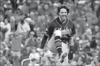  ?? CHARLIE RIEDEL/AP PHOTO ?? Dansby Swanson of the Atlanta Braves celebrates after scoring during the ninth inning in Game 3 of a National League Division Series against the St. Louis Cardinals on Sunday at St. Louis.