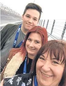  ?? SWNS. ?? Wullie’s son Jake, stepdaught­er Gemma Moore and wife Catherine as they cross the bridge.