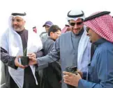  ??  ?? KUWAIT: EPA Board Chairman Sheikh Abdullah Ahmad AlHumoud Al-Sabah (center) distribute­s the plants. — KUNA
