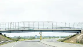  ??  ?? The operators of Highway 2000 had to erect a high fence along the overhead Bernard Lodge bridge to stop criminals who used to throw stones into the windscreen­s of motorists using the highway. The ploy led to many accidents and robberies.