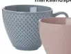  ??  ?? textured mugs in pink and blue, £5 each, marksandsp­encer.com