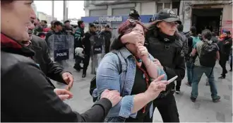  ??  ?? Policial conduz manifestan­te detida após tentar se dirigir à praça Taksim, em Istambul