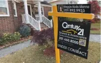  ?? AP PHOTO/TED SHAFFREY ?? An under-contract placard is shown on a home for sale sign in Lyndhurst, N.J., in November.