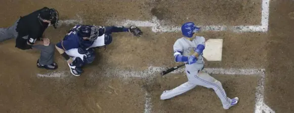  ?? MORRY GASH/THE ASSOCIATED PRESS ?? Blue Jays shortstop Ryan Goins hits a grand slam during the sixth inning of Toronto’s 8-4 win over Milwaukee on Wednesday. Full coverage on