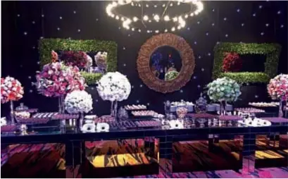  ??  ?? La torta de bodas de cuatro pisos estaba decorada con flores y la mesa dulce con coloridos bouquetes. A pedido de los novios, todo lo que se sirvió tenía dulce de leche.