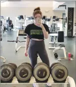  ?? Canadian Press photo ?? MacKenzie Parsons poses in this gym selfie at St. Thomas University in Fredericto­n in this recent handout photo. Parsons, who was told that the crop top she wore to a campus gym was too distractin­g, will get an apology from the university.