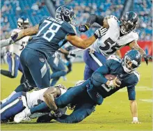  ?? WADE PAYNE THE ASSOCIATED PRESS ?? Tennessee Titans quarterbac­k Marcus Mariota is sacked, again, by Baltimore Ravens linebacker Patrick Onwuasor in last Sunday’s loss.