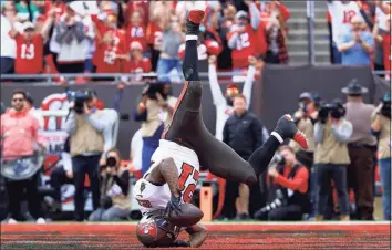  ?? Mike Ehrmann / Getty Images ?? Buccaneers running back Ke’Shawn Vaughn scores a touchdown against the Eagles during the first quarter on Sunday in Tampa, Fla.