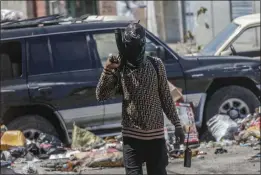  ?? ODELYN JOSEPH — THE ASSOCIATED PRESS ?? An armed member of the G9 and Family gang patrols a roadblock in the Delmas 6 neighborho­od of Port-au-Prince, Haiti, on Monday.