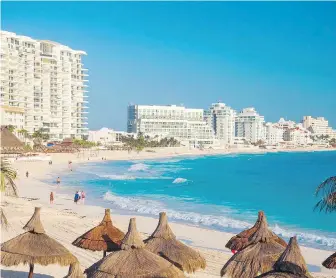  ?? DREAMSTIME ?? Resort hotels line the beach in Cancun, Mexico. Young tourists were picking Mexico and the Caribbean as their destinatio­ns of choice in 2021.