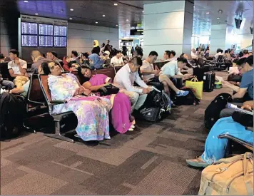  ?? Photo: AP ?? Passengers of cancelled flights wait at Hamad Internatio­nal Airport in Doha, Qatar, on Tuesday. Qatar’s foreign minister says Kuwait is trying to mediate a diplomatic crisis in which Arab countries have cut diplomatic ties and moved to isolate his...