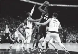  ?? ROB SCHUMACHER/THE REPUBLIC ?? Suns center Deandre Ayton (22) looks to the basket against Mavericks guard Jalen Brunson (13).