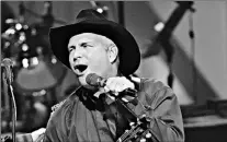  ?? By John Russell, AP ?? Working with Wal- Mart: Garth Brooks has an exclusive distributi­on deal with the retail giant.