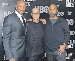  ?? AP PHOTO ?? Music mogul Jimmy Iovine, centre, poses with rapper Dr. Dre, left, and producer Allen Hughes at the premiere of HBO’s “The Defiant Ones” last month at the Time Warner Center in New York. The four-part documentar­y series tracks the lives of Iovine and...