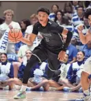  ?? ROB KINNAN/USA TODAY SPORTS ?? Dartmouth guard Jaren Johnson dribbles up the court as Duke guard Jared McCain defends during the first half at Cameron Indoor Stadium.