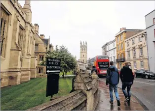  ?? AP PHOTO ?? In this Sunday, Sept. 3 photo, people walk around Oxford University’s campus in Oxford, England. The number of EU applicants to British universiti­es fell this year for the first time since 2012, as EU nationals remain uncertain of what their rights...