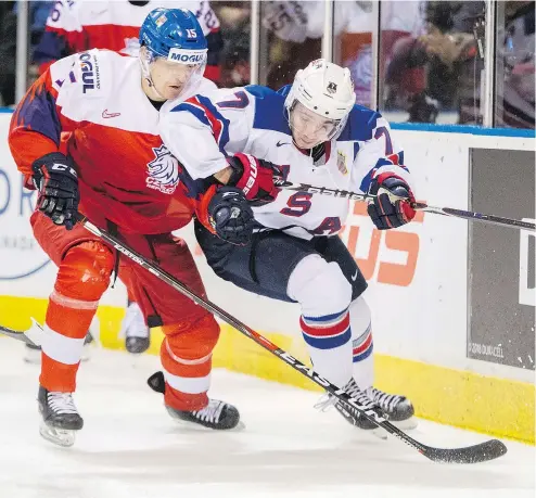  ?? — CP ?? The Czech Republic’s Jakub Lauko fights for position with Team USA defenceman Quinn Hughes during quarter-final action on Wednesday. Hughes, a Canucks prospect, leads the U.S. in ice time at around 22 minutes a game.