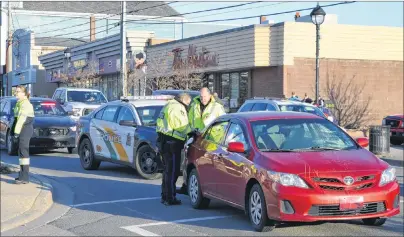  ?? SHARON MONTGOMERY-DUPE/CAPE BRETON POST ?? Const. David Vokey, left, of the Cape Breton Regional Police Service and Sgt. Joe Farrell, of the traffic safety unit, investigat­e at the scene of a motor vehicle/pedestrian mishap Friday where two women were hit while in a crosswalk on Commercial...