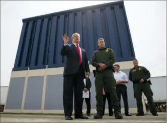  ?? EVAN VUCCI — THE ASSOCIATED PRESS FILE ?? In this file photo, President Donald Trump talks with reporters as he reviews border wall prototypes in San Diego. Trump is floating the idea of using the military’s budget to pay for his long-promised border wall with Mexico. Trump raised the idea to...