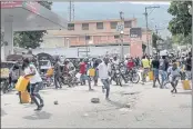  ?? MATIAS DELACROIX — THE ASSOCIATED PRESS ?? Residents flee as police fire shots to disperse a crowd whose members had threatened arson Saturday at a gas station in Port-au-Prince, Haiti.