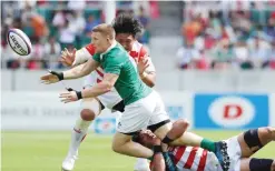  ??  ?? SHIZUOKA: Ireland’s Andrew Conway (C) is tackled by Japan’s players during their rugby union Test match in Shizuoka yesterday. Ireland gave Japan a brutal reality check as they crushed the Asian champions 50-22 yesterday in the second of their...