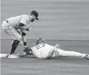  ?? JOE PUETZ/AP ?? Marlins second baseman Jon Berti tags out the Cardinals’ Tyler O’Neill on a steal attempt during the second inning of Tuesday night’s game in St. Louis.