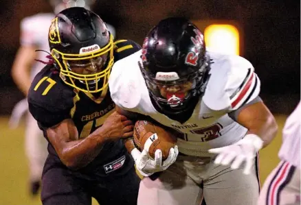  ?? STAFF PHOTO BY ROBIN RUDD ?? McMinn County’s Jalen Hunt, left, brings down Maryville’s Cole Roberts during Friday night’s matchup of undefeated teams in Athens, Tenn. The host Cherokees lost 21-2 as Maryville won the Region 2-6A championsh­ip and extended a long run of league dominance.