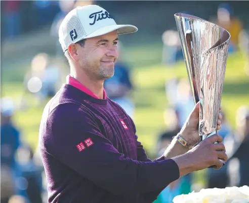  ?? Picture: GETTY IMAGES/AFP ?? WINNING GRIN: Adam Scott holds the trophy following the final round of the Genesis Invitation­al.