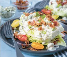  ?? DREAMSTIME ?? This classic wedge salad is embellishe­d with pancetta and cherry tomatoes.