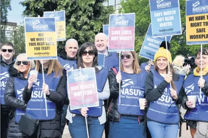  ??  ?? Unrest Teachers from both schools during a strike outside Motherwell civic centre last month