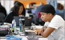  ?? PHOTO BY JASON GETZ ?? Josiah Howard, 18, works on a computer last month at Graduation Achievemen­t Charter High School in Atlanta.