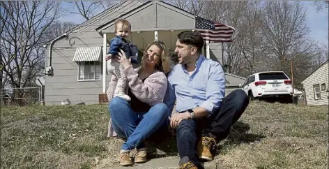  ?? CHARLIE RIEDEL / Ap ?? Logan Dewitt with his wife Mckenzie and daughter Elizabeth sit on the steps leading to their home Monday in Kansas city, Kan. Because he could work at home, Logan kept his job through the pandemic while his wife lost hers and went back to school. their financial situation was further complicate­d with the birth of their daughter nine months ago.