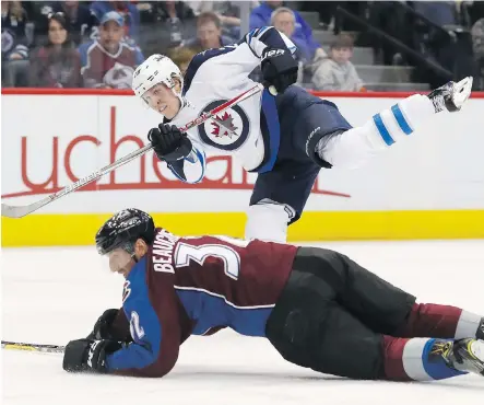  ?? DAVID ZALUBOWSKI/THE ASSOCIATED PRESS ?? Winnipeg right-winger Patrik Laine shoots over Colorado defenceman Francois Beauchemin Saturday in Denver. The Jets lost the game 5-2, ending the opportunit­y for the club to win four consecutiv­e games for the first time since last season.