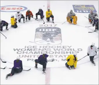  ??  ?? Members of the U.S. women’s hockey team stretch during practice Thursday in Plymouth, Mich.