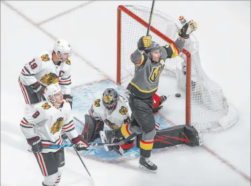  ?? Jason Franson The Associated Press ?? Reilly Smith celebrates scoring the winning goal on Blackhawks goalie Corey Crawford in the 4-3 overtime win in Game 2 of the Western Conference quarterfin­als.