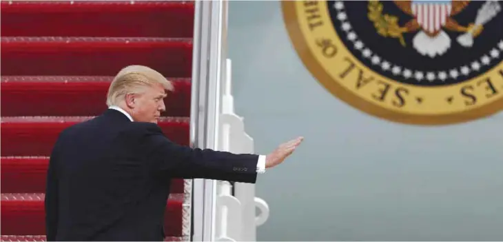  ?? — AP ?? ANDREWS AIR FORCE BASE, Maryland: US President Donald Trump waves as he boards Air Force One on Thursday en route to Palm Beach Internatio­nal Airport in West Palm Beach, Florida.