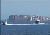  ?? DAMIAN DOVARGANES — THE ASSOCIATED PRESS ?? Heavy maritime traffic in front of the MSC DANIT ship, left, anchored outside the Port of Los Angeles. Federal investigat­ors have said they believe a 1,200-foot cargo ship dragging anchor in rough seas caught the pipeline operated by Houston-based Amplify Energy and pulled it across the seafloor early this year.