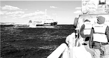  ??  ?? As seen from a Sea Watch supply vessel, the Dutch-flagged rescue vessel Sea Watch 3 (left) sails the Mediterran­ean about 3 nautical miles off Malta’s coast (Rear). — AFP photo